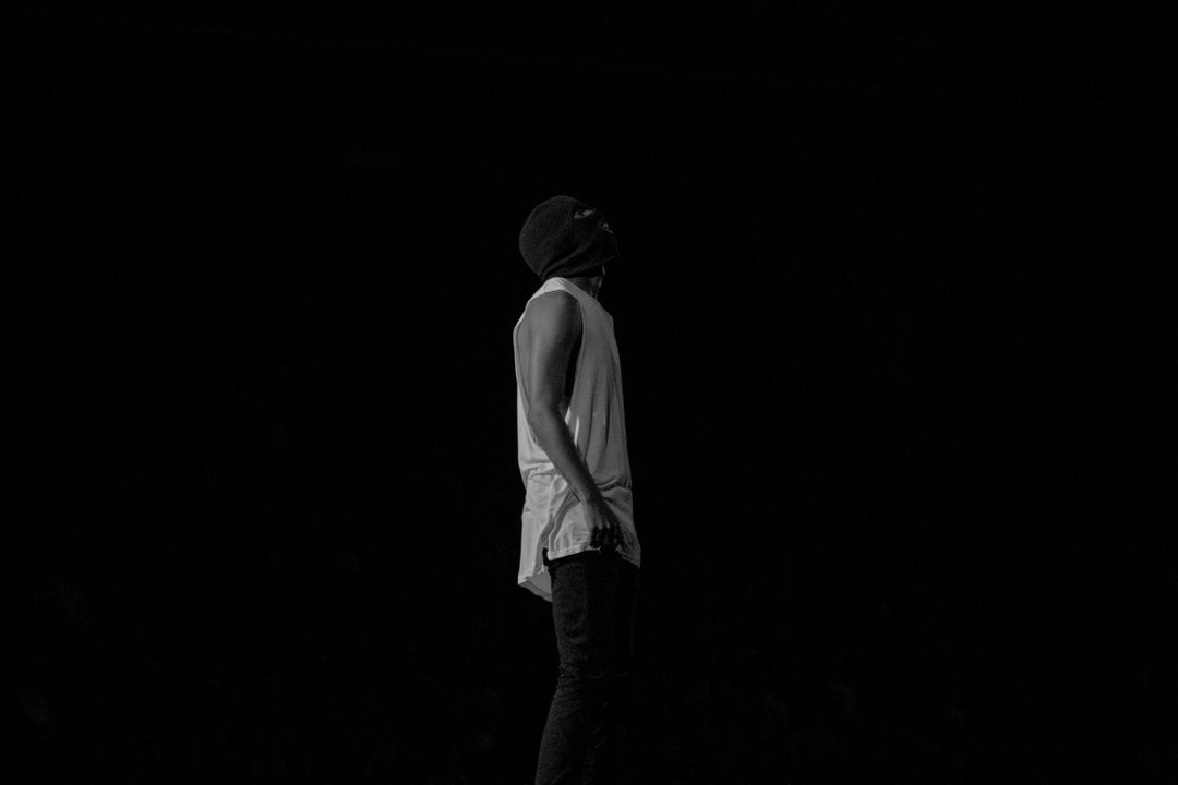 Person in Beanie Looking Up While Standing in Darkness - Free Images, Stock Photos and Pictures on Pikwizard.com