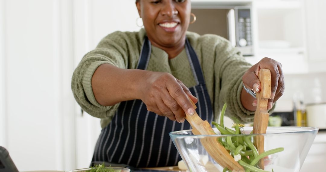 Smiling Woman Preparing Healthy Meal in Modern Kitchen - Free Images, Stock Photos and Pictures on Pikwizard.com