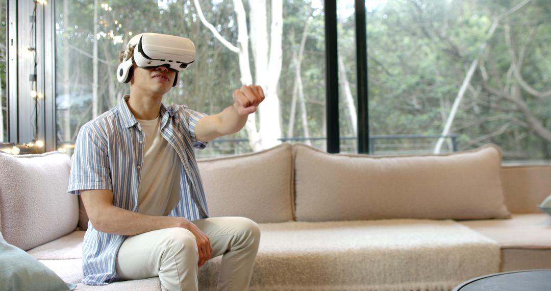 Young Man Enjoying Virtual Reality Experience at Home