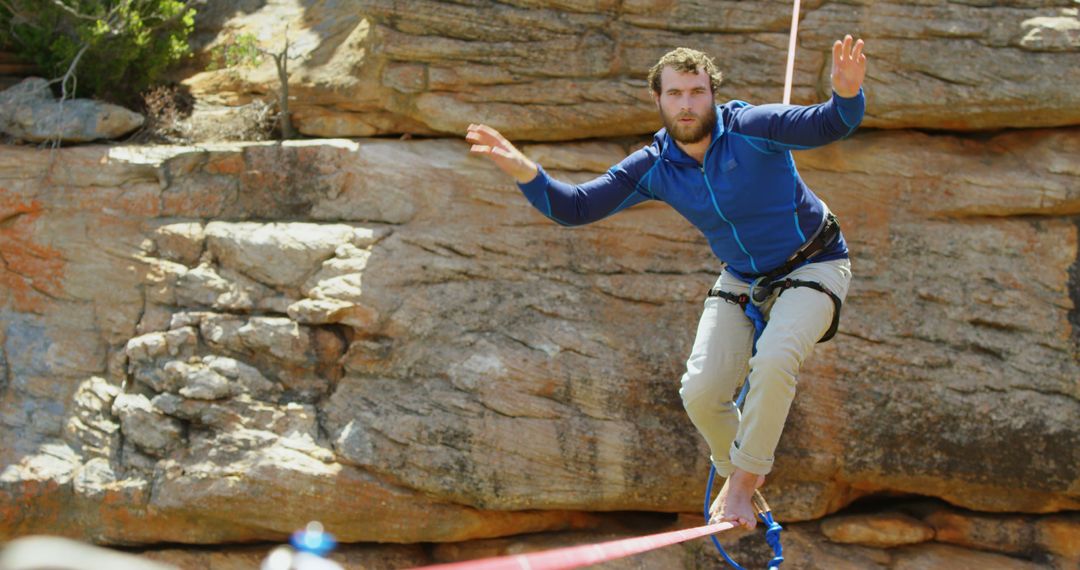 Man Balancing on Tightrope in Rocky Outdoor Landscape - Free Images, Stock Photos and Pictures on Pikwizard.com