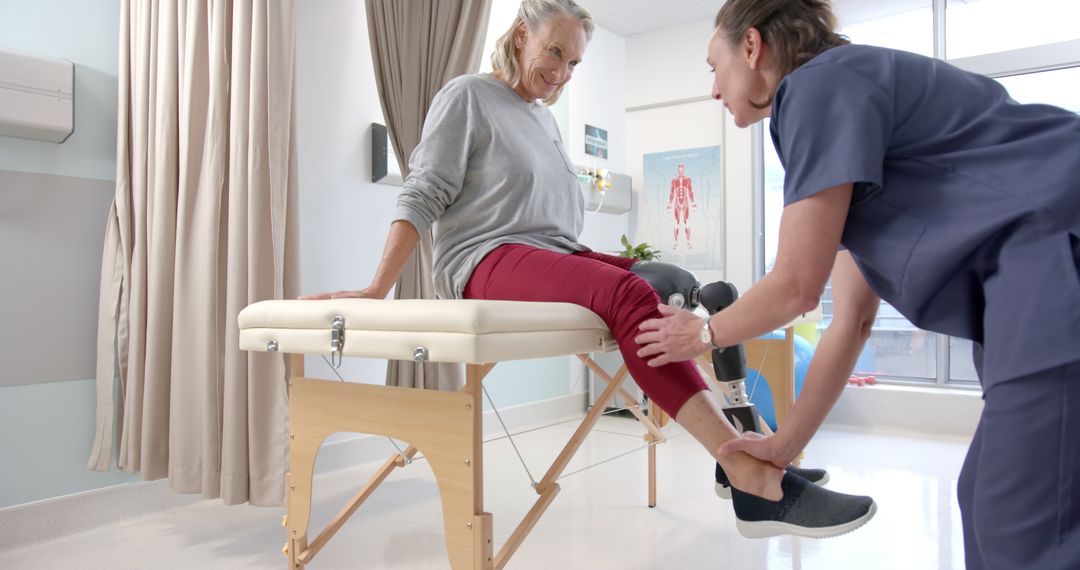 Physiotherapist Assisting Elderly Woman with Leg Exercises in Clinic - Free Images, Stock Photos and Pictures on Pikwizard.com