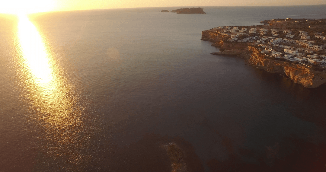 Transparent Sunset Over Ocean and Coastal Cliffs