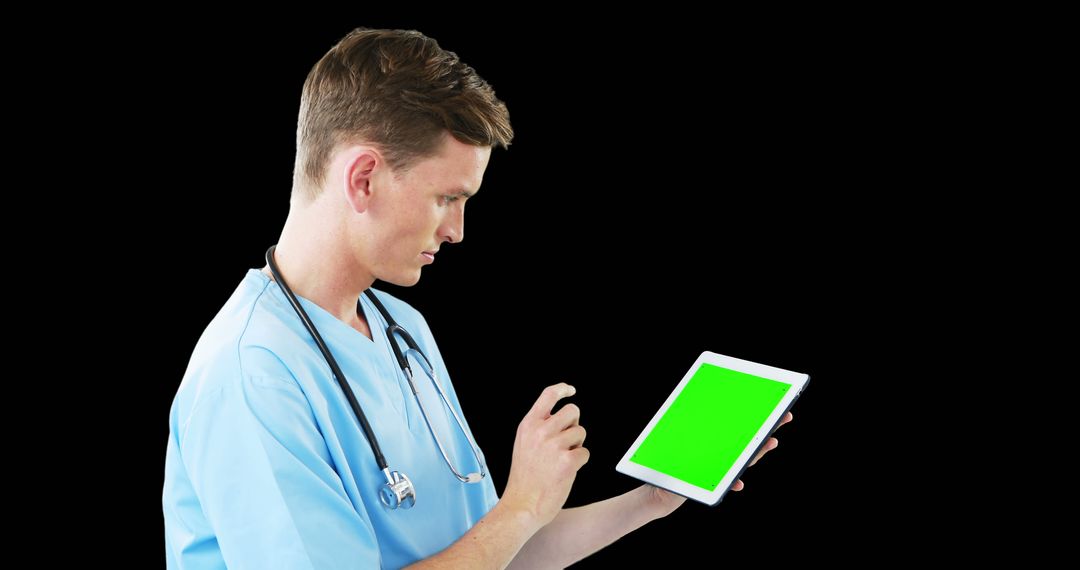 Male Surgeon Using Digital Tablet on Isolated Black Background - Free Images, Stock Photos and Pictures on Pikwizard.com