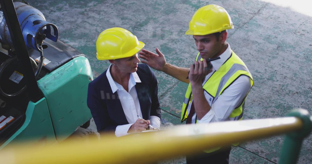Supervisor manager discussing forklift safety operations during warehouse inspection