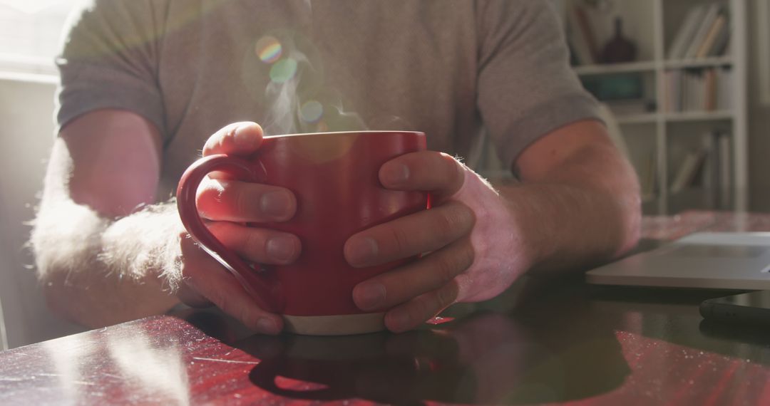 Person Drinking Morning Coffee at Sunrise in Cozy Home - Free Images, Stock Photos and Pictures on Pikwizard.com