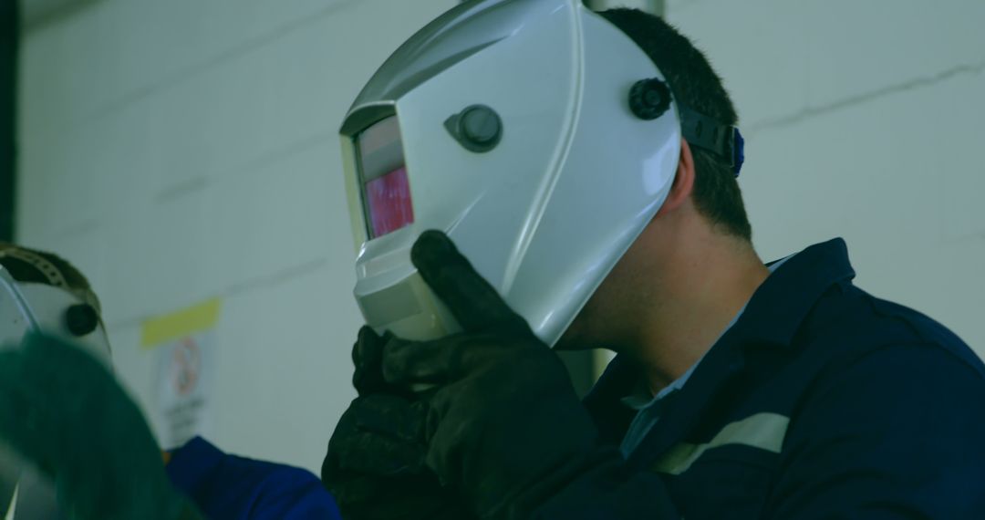 Industrial Worker Adjusting Safety Helmet in Factory - Free Images, Stock Photos and Pictures on Pikwizard.com