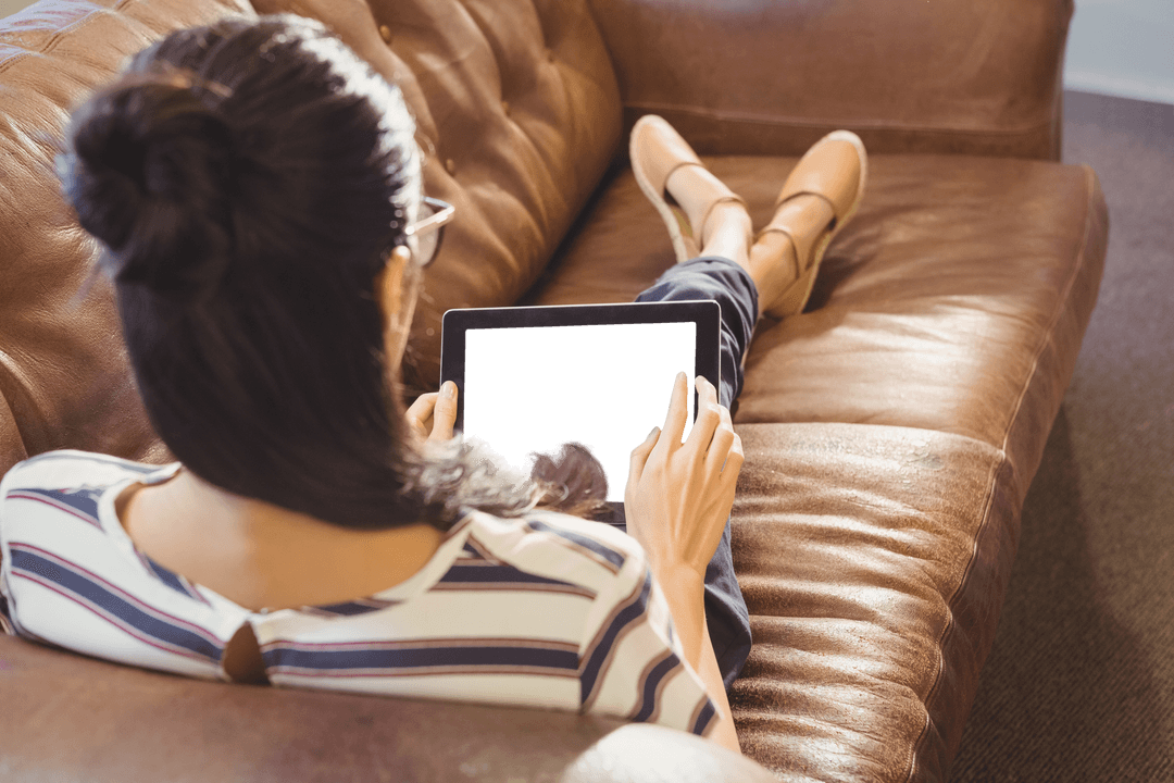 Transparent Tablet Used by Businesswoman Relaxing on Sofa