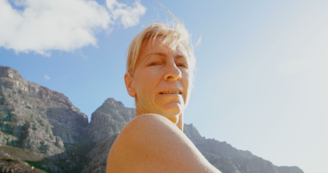 Senior Woman Enjoying Outdoor Adventure Amidst Mountain Scenery - Free Images, Stock Photos and Pictures on Pikwizard.com