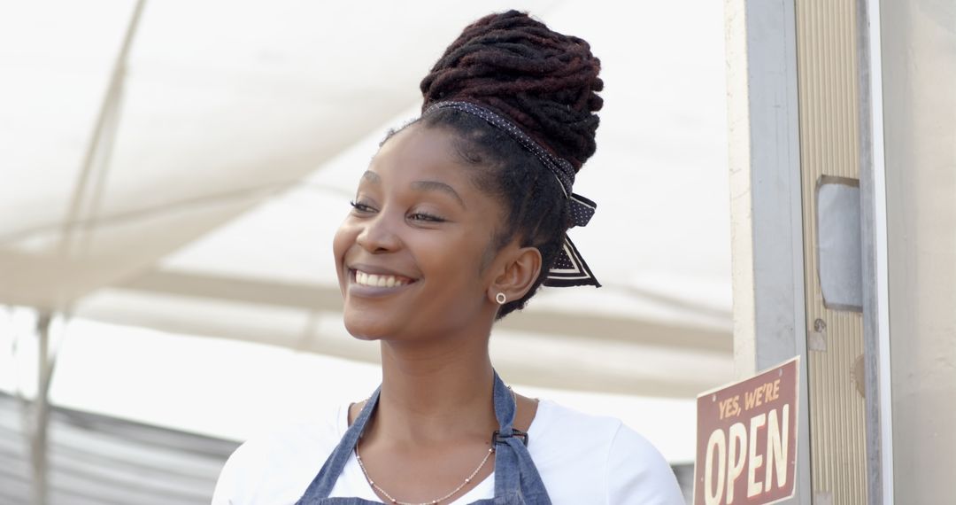 Smiling Female Vendor at Community Marketplace Stall