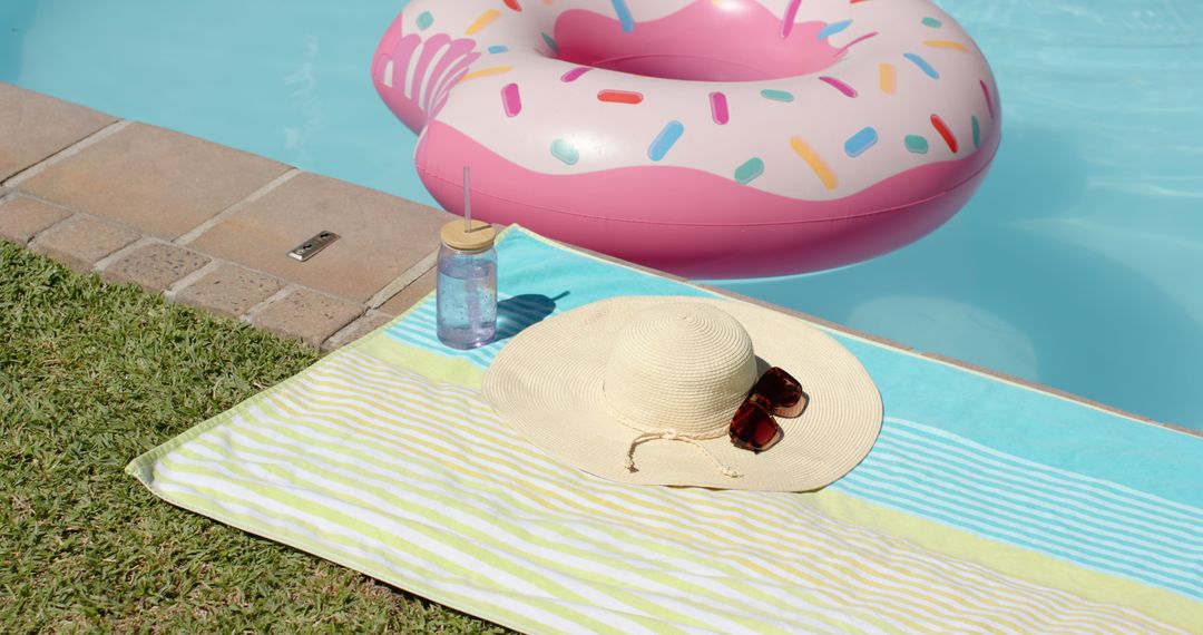 Poolside Relaxation with Inflatable Donut and Towel