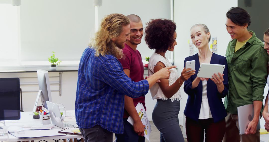 Diverse Team Engaged in Collaborative Tech-Savvy Workplace Discussion