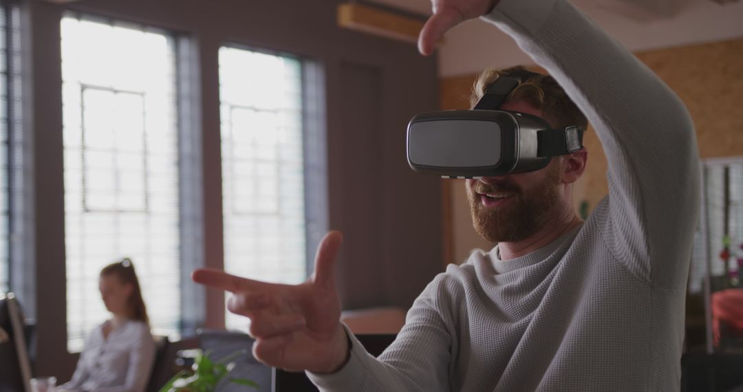 Man enjoying virtual reality experience in office - Free Images, Stock Photos and Pictures on Pikwizard.com