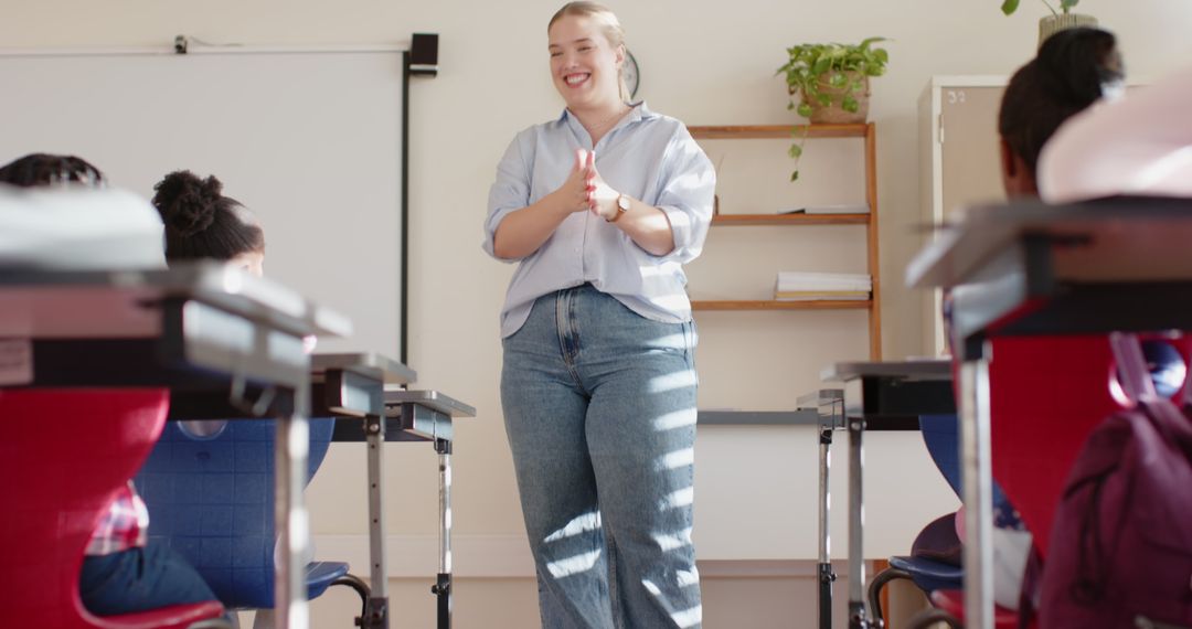 Enthusiastic Female Teacher Engages Elementary Students in Classroom Activity
