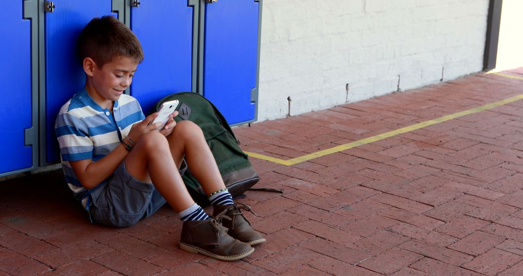 Young Boy Enjoying Smartphone Rich Break Time in School Environment