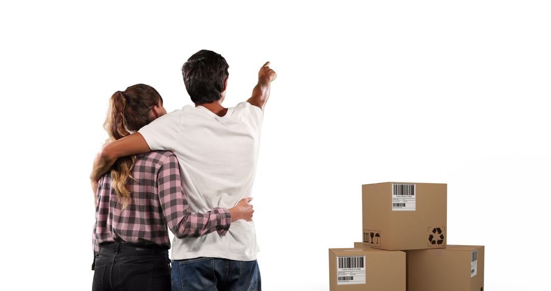 Couple Embracing with Moving Boxes Visioning Future Home