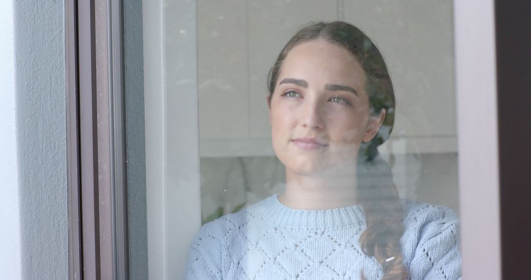 Woman Gazing Through Window with Thoughtful Expression - Free Images, Stock Photos and Pictures on Pikwizard.com