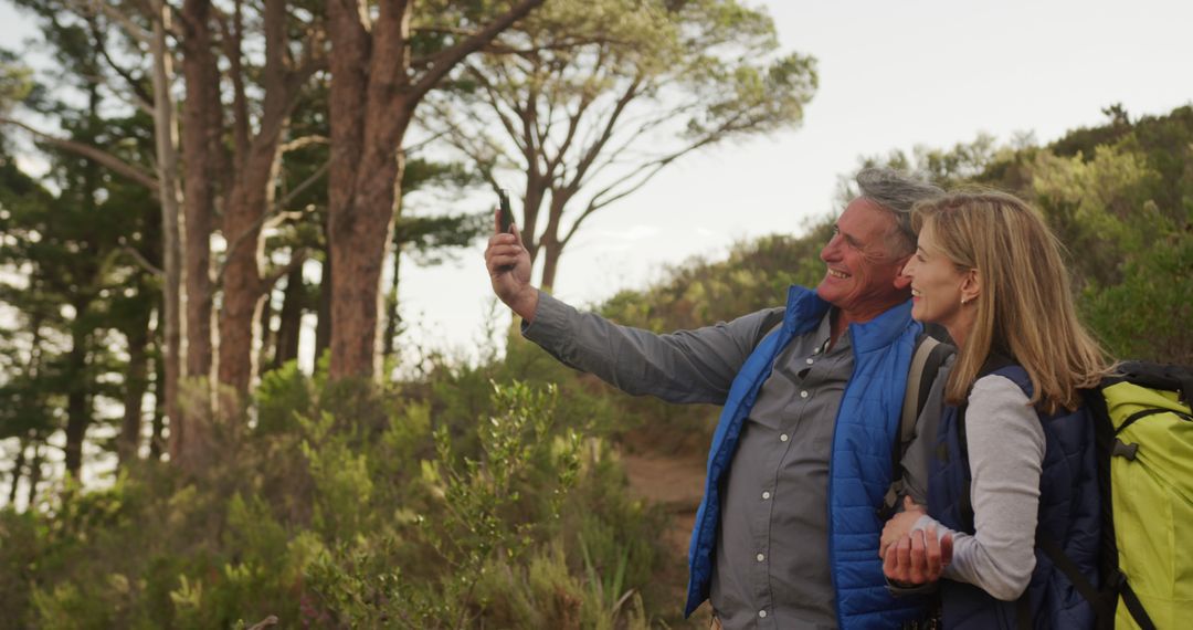 Senior Couple Taking Selfie While Hiking in Scenic Forest