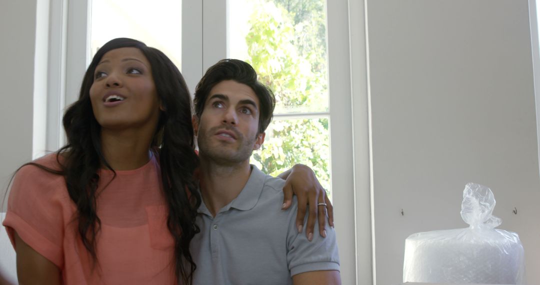 Happy Couple Sitting Together Inside New Home