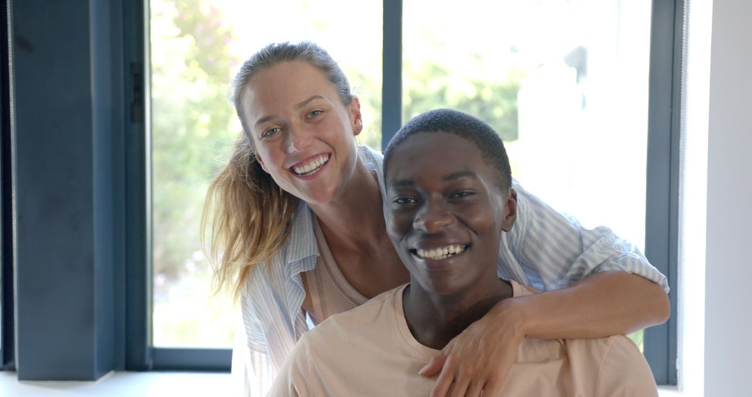 Smiling Diverse Couple Embracing in Modern Home Interior