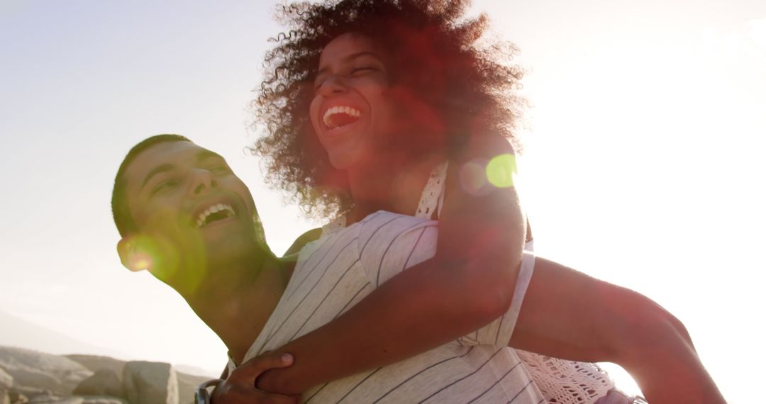 Joyful Beach Piggyback Ride with Interracial Couple