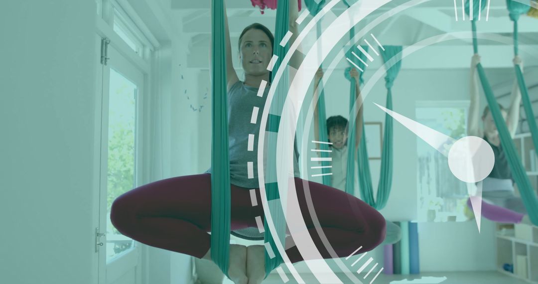 Diverse Female Instructor and Teens Practicing Aerial Yoga