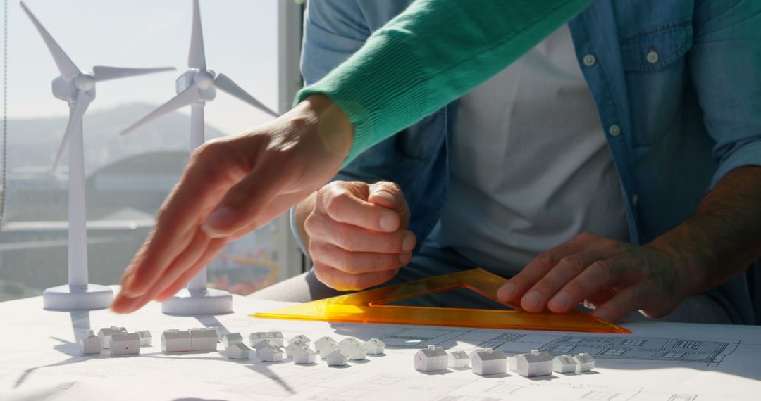 Colleagues Collaborating on Sustainable Architecture Blueprint