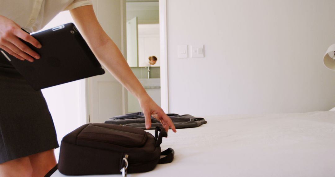 Businesswoman Packing Bag in Bright Hotel Room - Free Images, Stock Photos and Pictures on Pikwizard.com