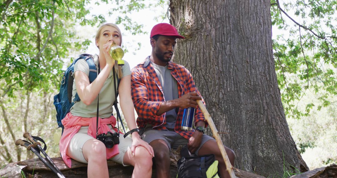 Couple Taking a Break While Hiking in Forest