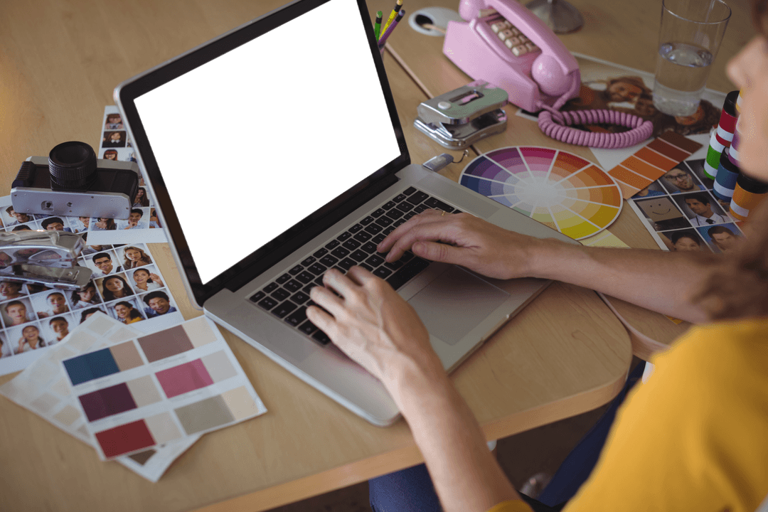 Graphic Designer Using Laptop in Colorful Creative Workspace