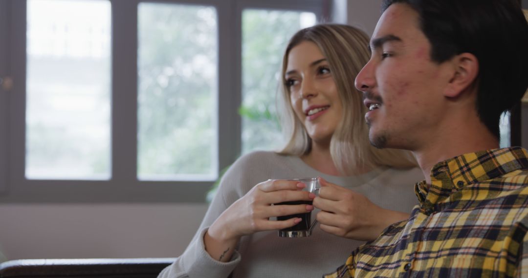 Couple Relaxing Together with Coffee at Home Couch
