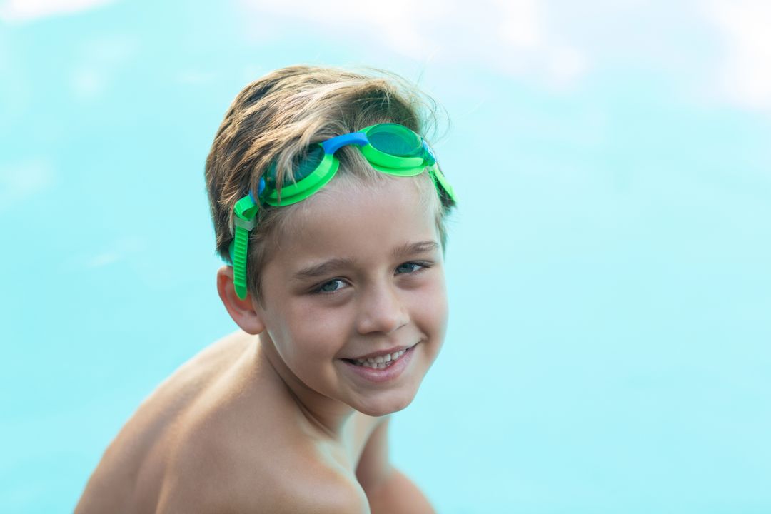 Smiling little boy wearing green swimming goggles - Free Images, Stock Photos and Pictures on Pikwizard.com