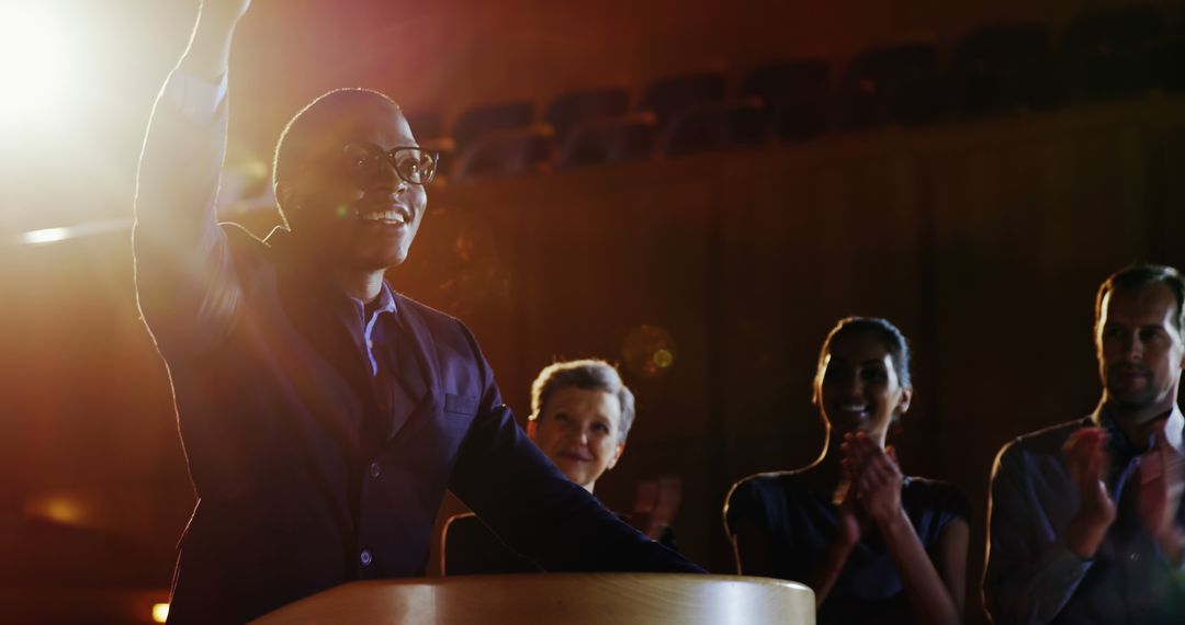 Smiling Businessman Receiving Applause from Colleagues