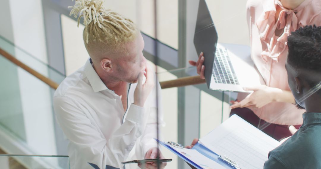 Team Collaborating with Technology in Modern Office