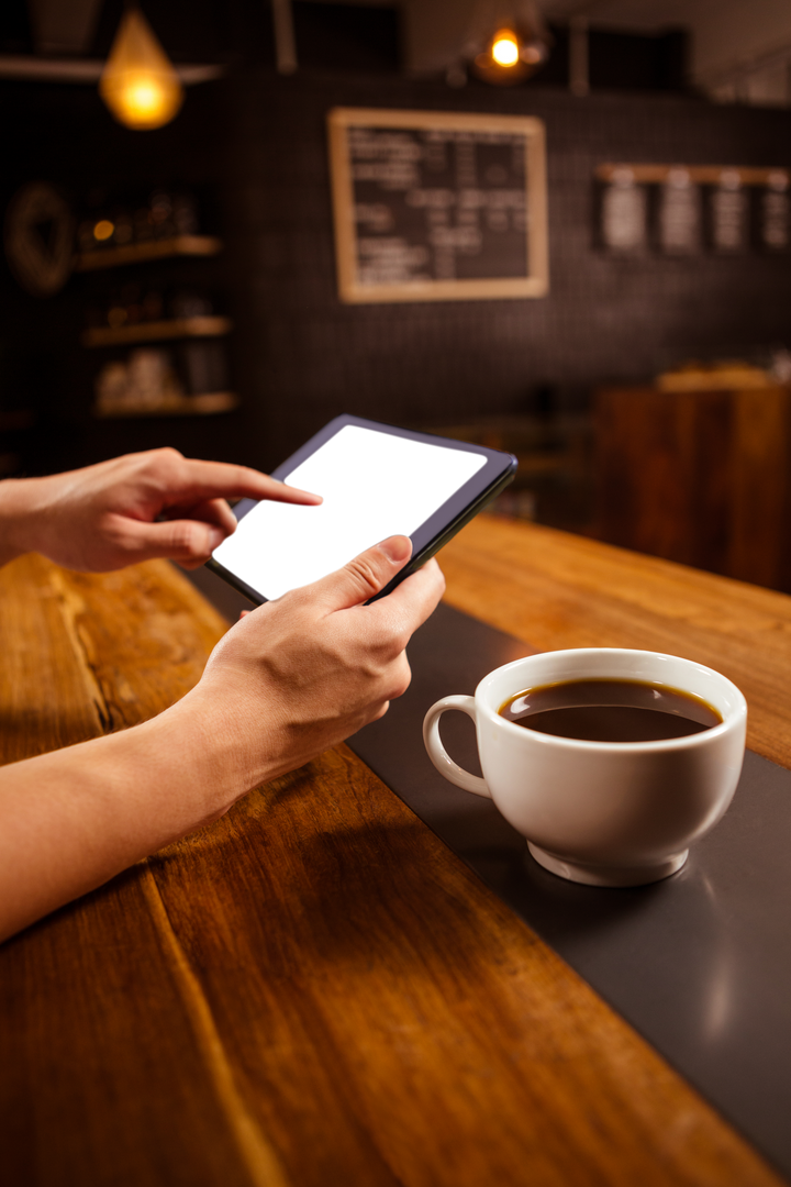 Transparent Tablet Use with Coffee in Cozy Cafe Setting - Download Free Stock Images Pikwizard.com