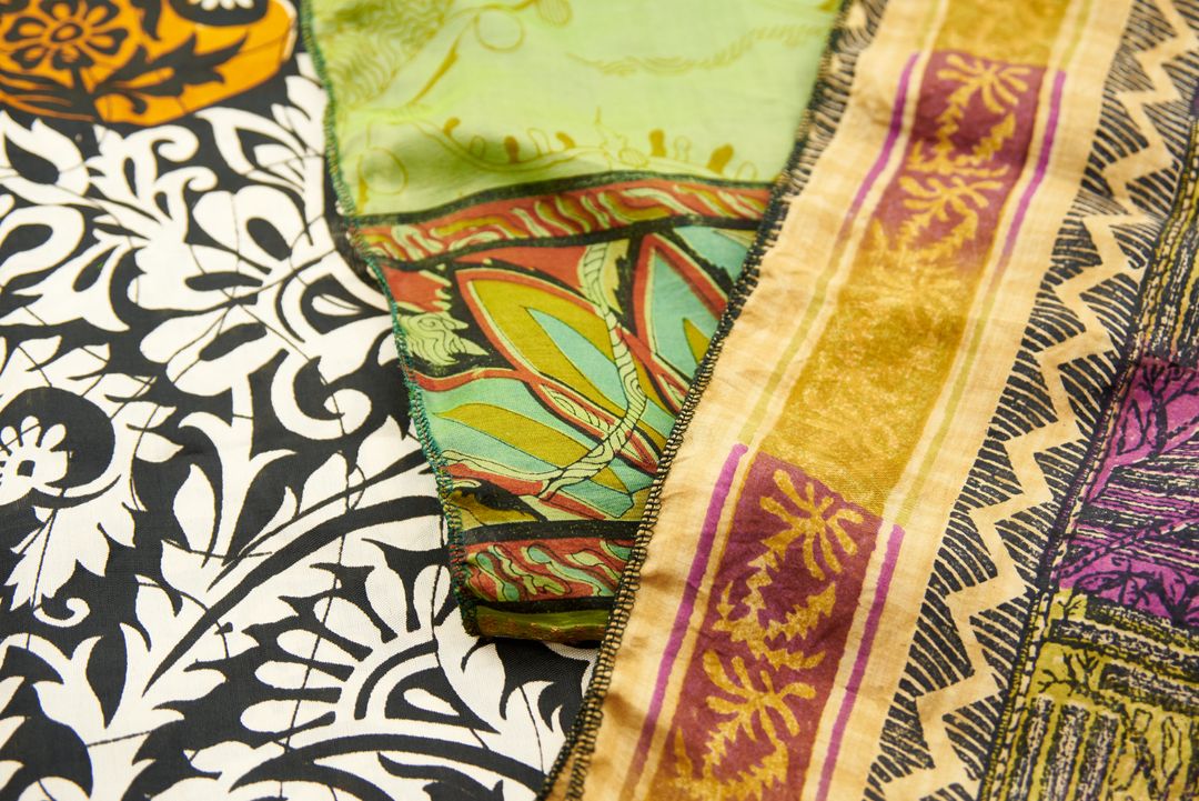 Layering vibrant patterned fabrics with bohemian floral and geometric motifs