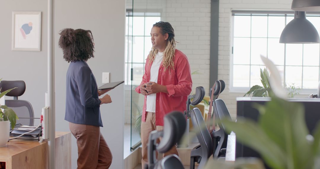 Colleagues Discussing Work with Tablet in Modern Office