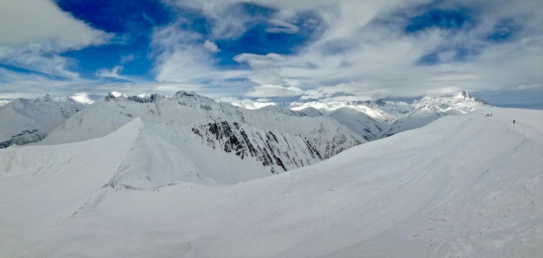 Panoramic View of Snow-Covered Mountain Range under Cloudy Sky - Free Images, Stock Photos and Pictures on Pikwizard.com