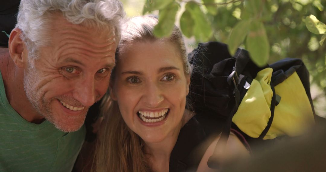 Joyful Hiking Couple Enthusiastically Pointing in Green Forest