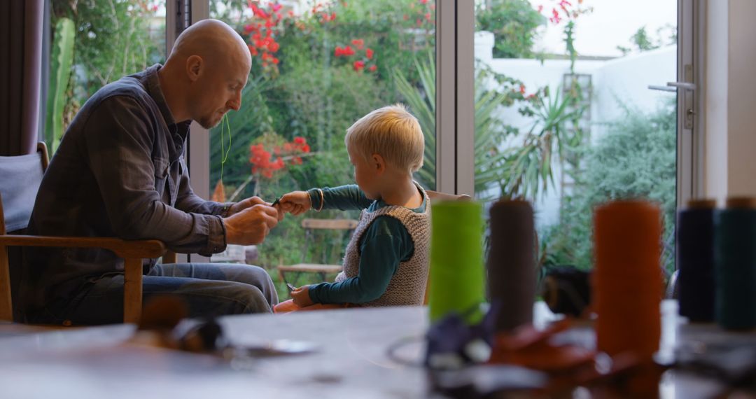 Father Teaching Son Craftsmanship with Keychain Project at Home