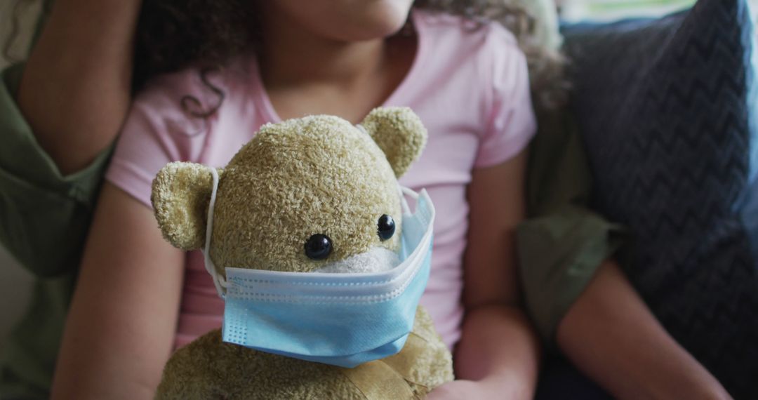 Child with Teddy Bear in Face Mask Embraces Parenthood Bond - Free Images, Stock Photos and Pictures on Pikwizard.com