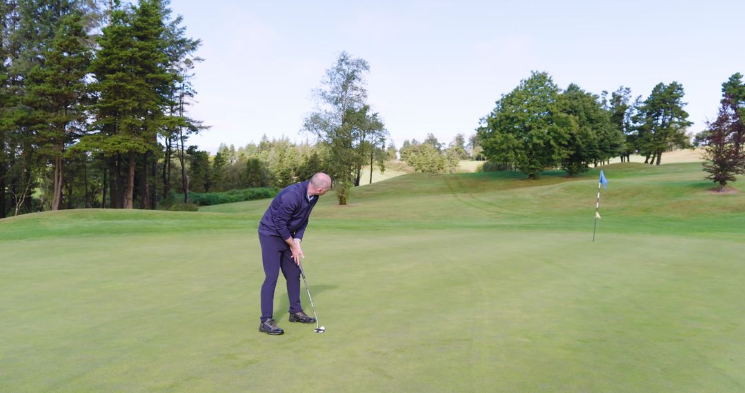Man Practicing Putting Skills on Tranquil Golf Course Green