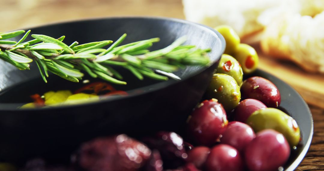 Mediterranean Cuisine Close-Up with Fresh Olives and Rosemary - Free Images, Stock Photos and Pictures on Pikwizard.com