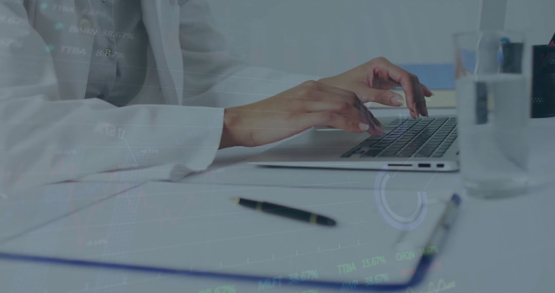 Woman Analyzing Data on Laptop in Modern Office Environment