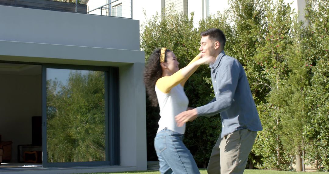 Diverse Couple Embracing Outside Modern House