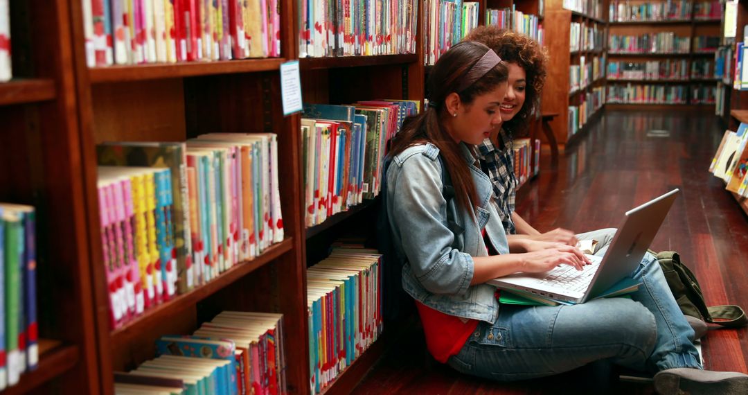 Two Students Studying Together in Library with Laptop - Free Images, Stock Photos and Pictures on Pikwizard.com