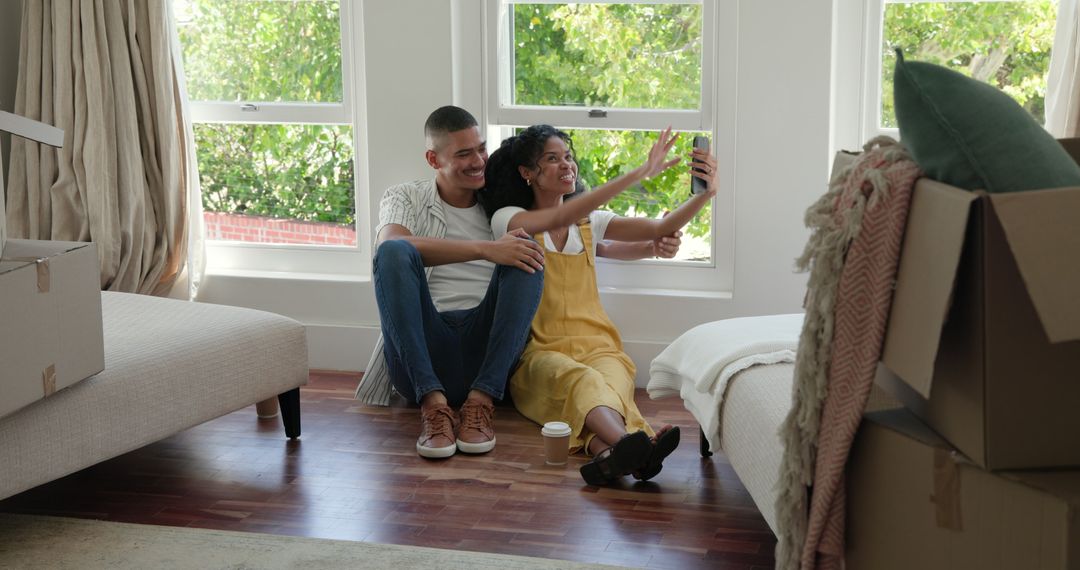 Happy Couple Capturing Memories While Unpacking in New Home