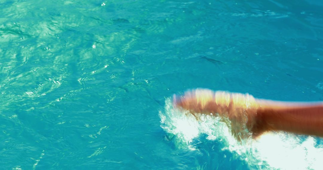 Close-up of person foot splashing in clear blue water - Free Images, Stock Photos and Pictures on Pikwizard.com