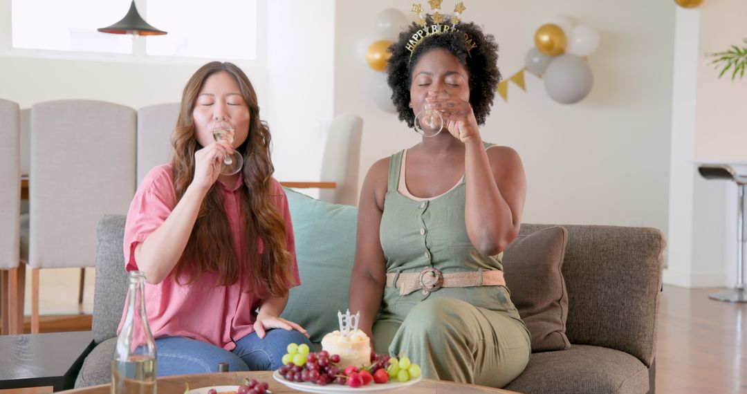 Diverse Friends Celebrating Birthday on Couch with Cake and Drinks