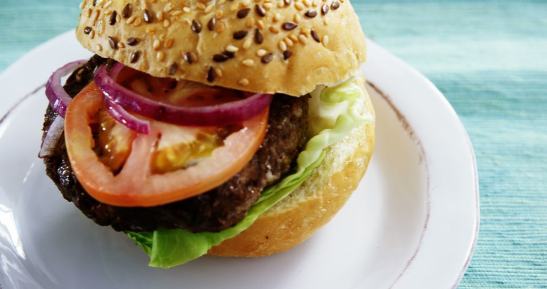 Delicious Handmade Burger with Vegetables on White Plate - Free Images, Stock Photos and Pictures on Pikwizard.com