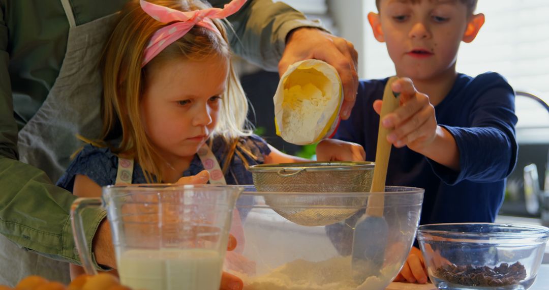 Children Baking Cake with Adult Assistance in Kitchen - Free Images, Stock Photos and Pictures on Pikwizard.com